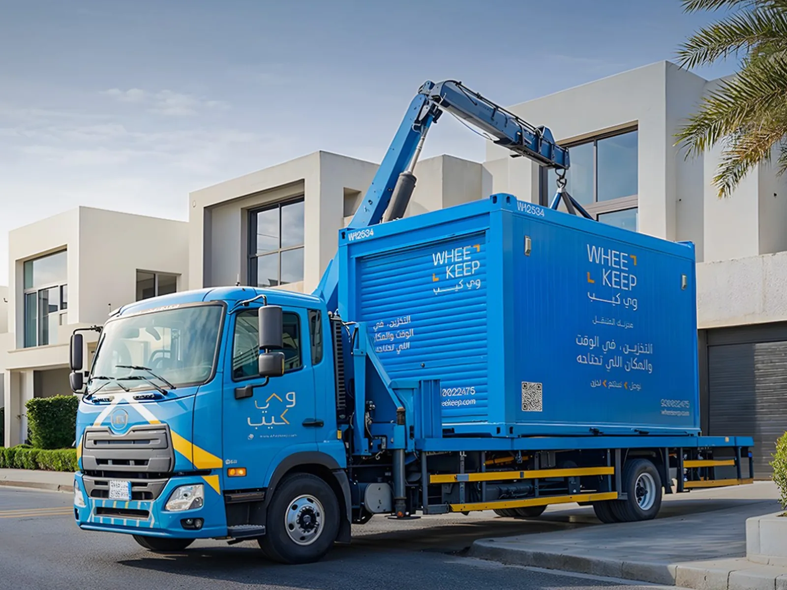 A WheeKeep crane truck lowering a storage unit outside a building