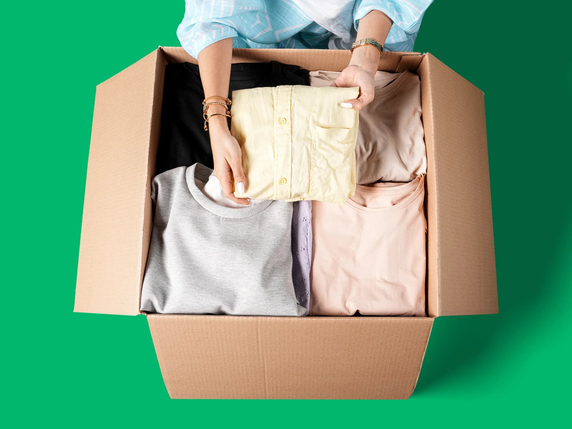 Packing clothes into a box before a trip