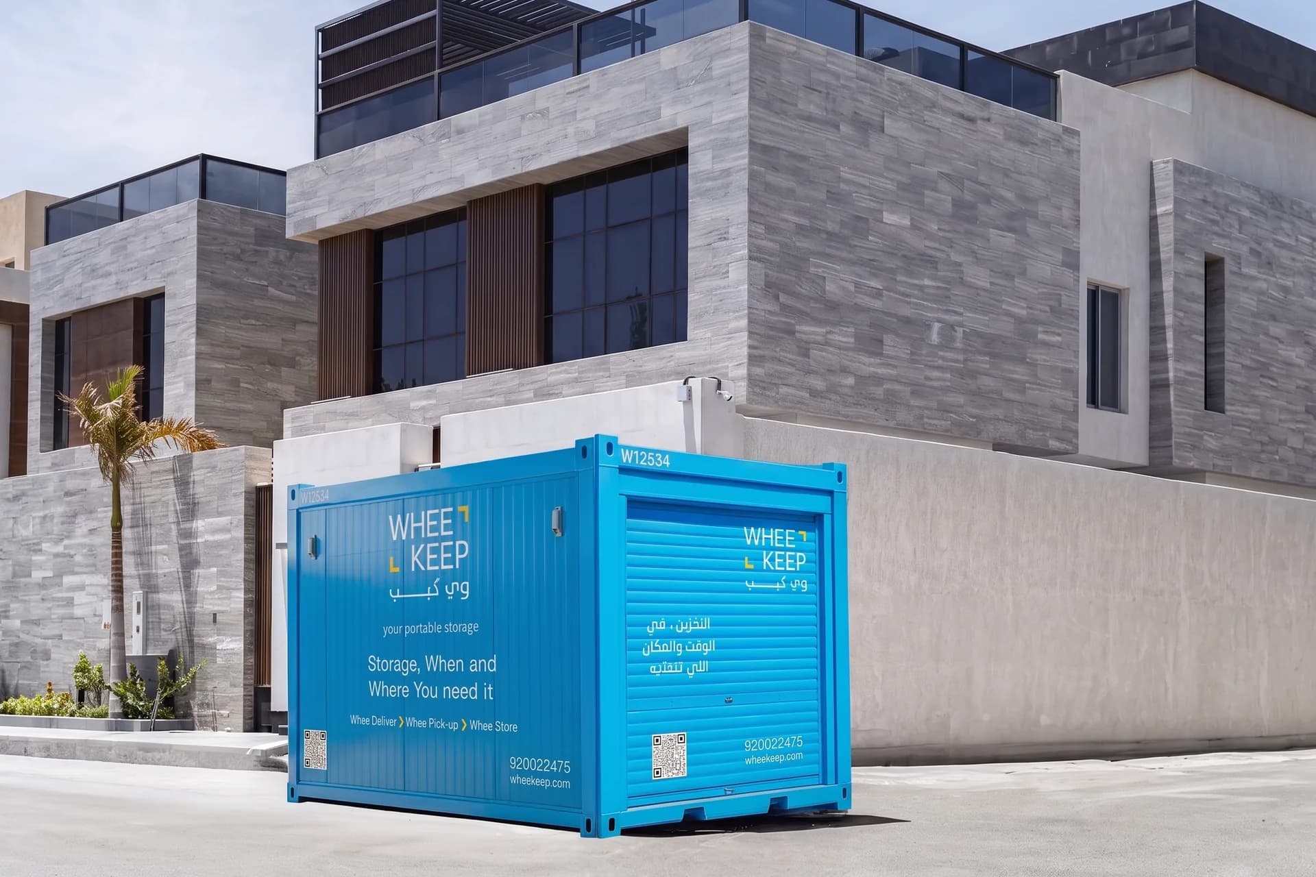 A WheeKeep roll-up-door storage unit outside a modern villa