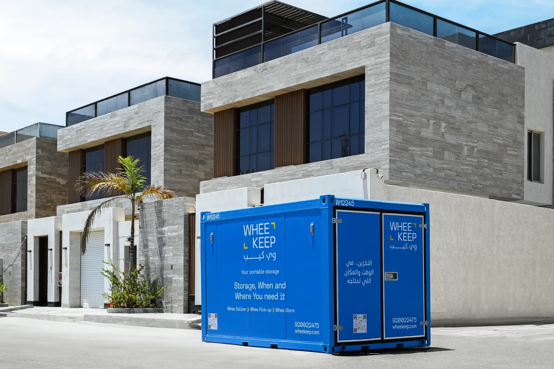 A WheeKeep storage unit outside a large villa
