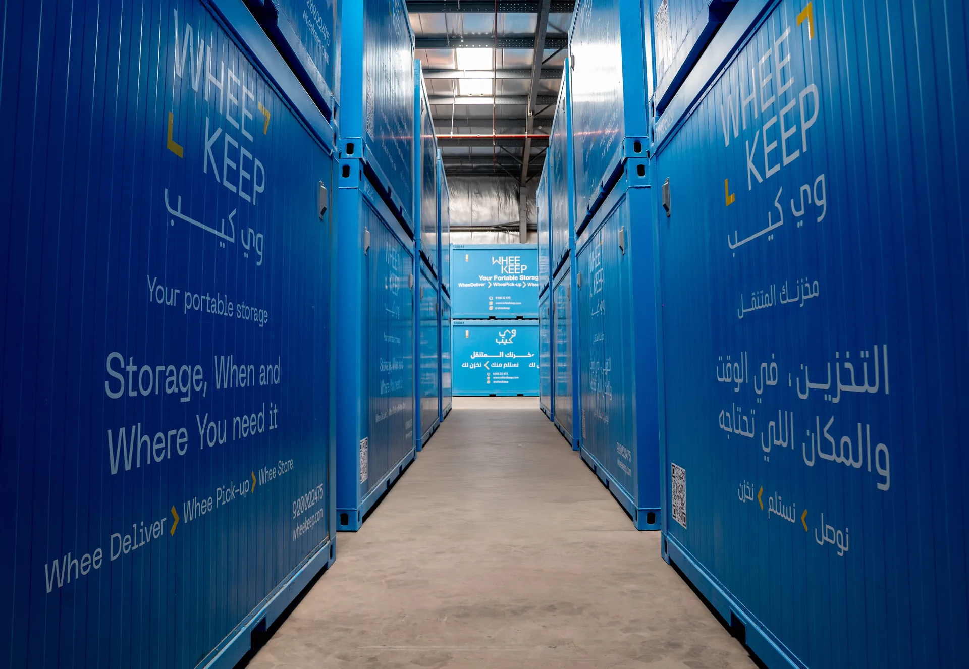 An aisle between stacked WheeKeep units inside the warehouse