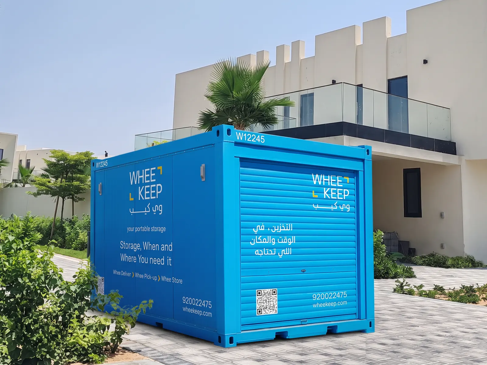 A WheeKeep roll-up-door storage unit outside a villa